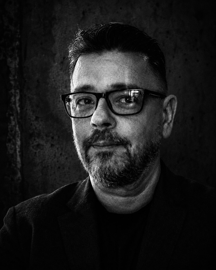 Black and white portrait of Attila Siklósi against a concrete wall