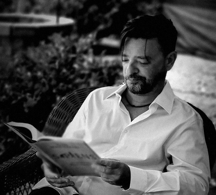 Attila Siklósi reading in a garden